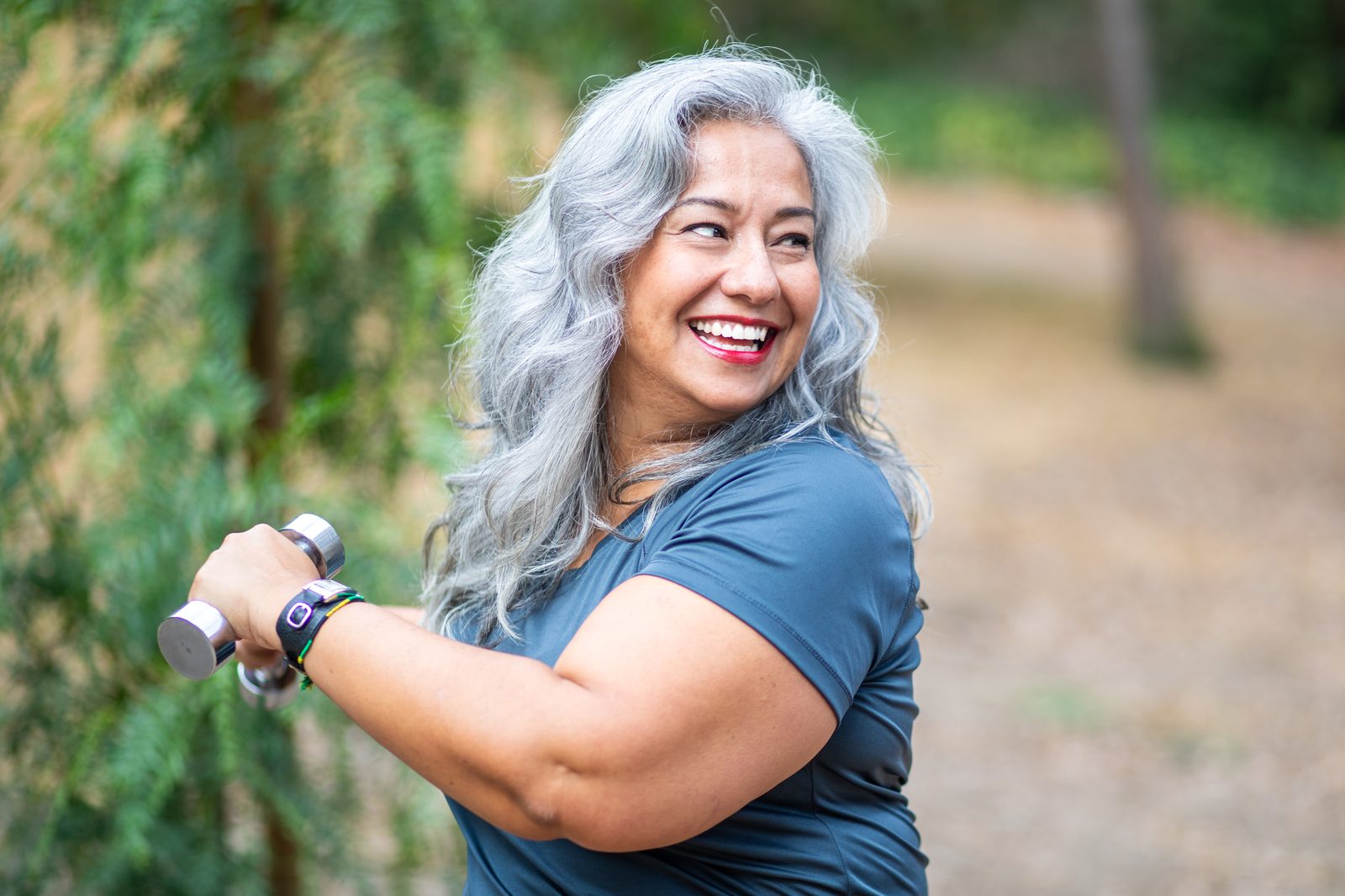 A warm, smiling person outdoors