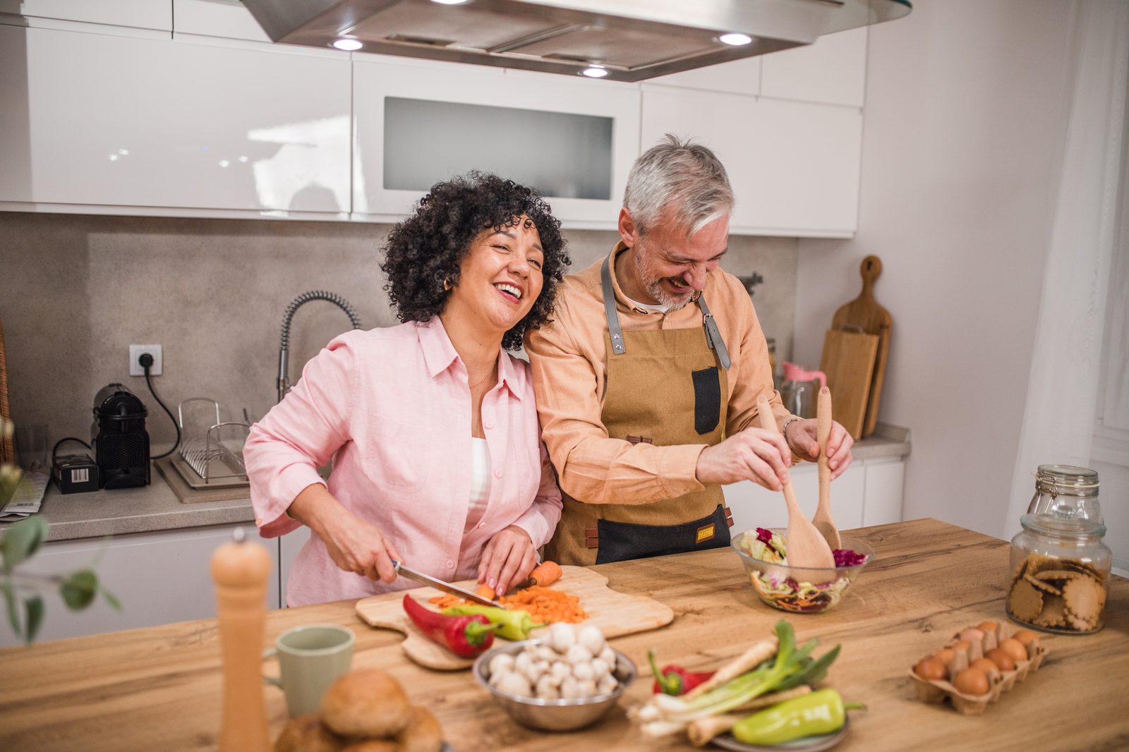 Two people cooking a nourishing meal together at home